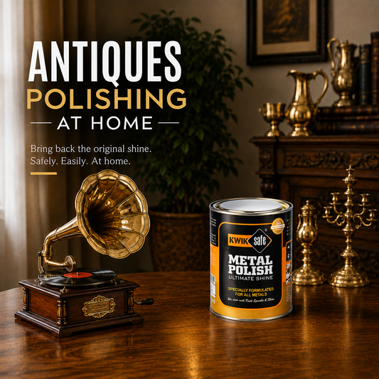 A can of Kwik Safe Metal Polish Ultimate Shine sits on a polished wooden table next to a vintage wooden gramophone in a warmly lit antique-filled room. Large text on the left reads 'ANTICS POLISHING AT HOME'.